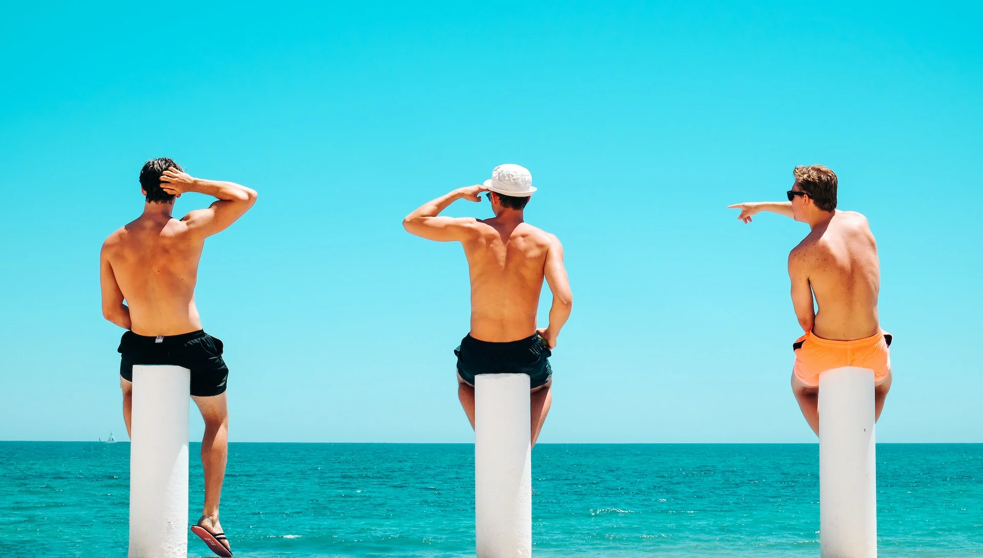 three-male-friends-bonding-at-beach